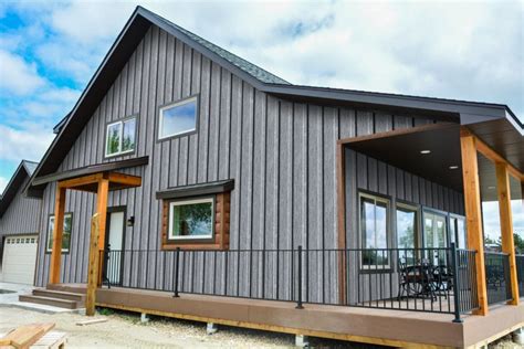 green house with black metal roof|black roof with gray siding.